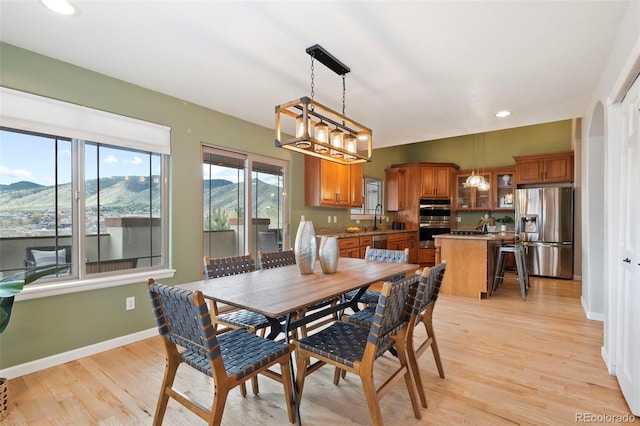 415 Butte Pkwy, Golden, CO 80403 - dining room with light wood-type flooring, baseboards, recessed lighting, and a mountain view