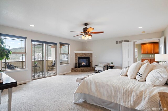415 Butte Pkwy, Golden, CO 80403 - carpeted bedroom featuring access to exterior, baseboards, a glass covered fireplace, recessed lighting, and ceiling fan