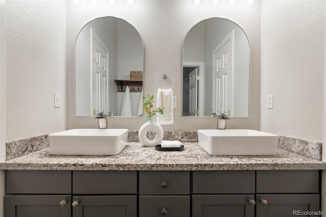415 Butte Pkwy, Golden, CO 80403 - bathroom with double vanity and a textured wall