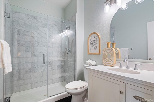 415 Butte Pkwy, Golden, CO 80403 - bathroom featuring vanity, a stall shower, and toilet