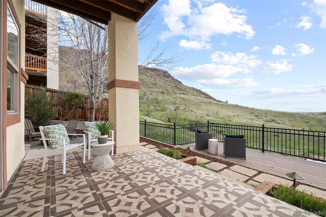 415 Butte Pkwy, Golden, CO 80403 - fenced backyard featuring a patio and a deck with mountain view