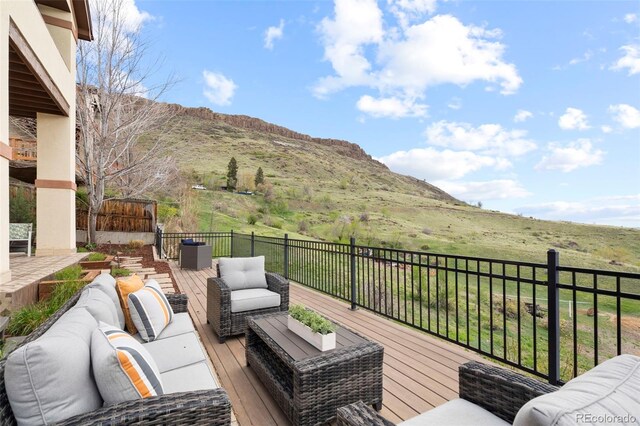 415 Butte Pkwy, Golden, CO 80403 - wooden deck featuring an outdoor living space and a mountain view