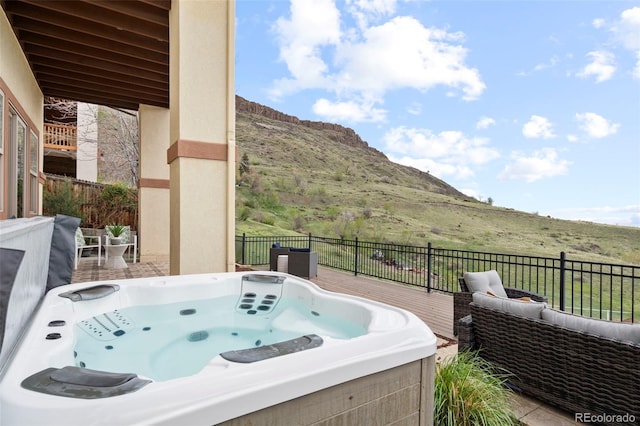 415 Butte Pkwy, Golden, CO 80403 - view of patio featuring a hot tub and a deck with mountain view