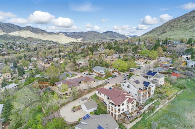 415 Butte Pkwy, Golden, CO 80403 - aerial overview of property's location with a mountain backdrop and nearby suburban area