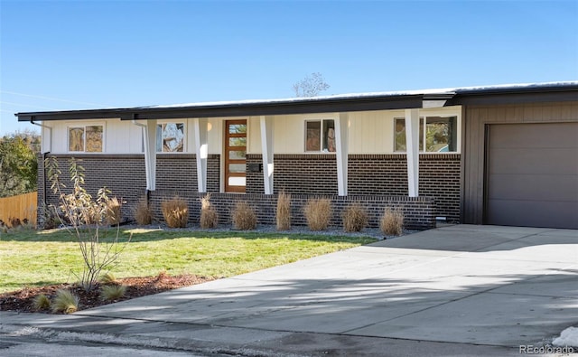 view of front of house with a garage and a front lawn