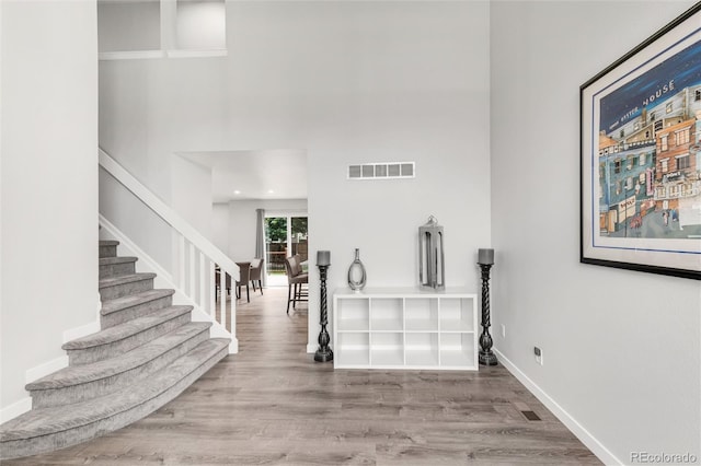 10591 Hyacinth St, Highlands Ranch, CO 80129 - foyer featuring stairs, wood finished floors, a towering ceiling, and baseboards