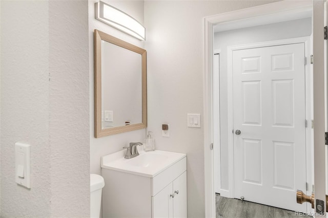 10591 Hyacinth St, Highlands Ranch, CO 80129 - bathroom featuring toilet, vanity, and wood finished floors