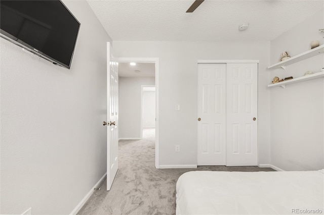 10591 Hyacinth St, Highlands Ranch, CO 80129 - carpeted bedroom with a closet, baseboards, a textured ceiling, and a ceiling fan