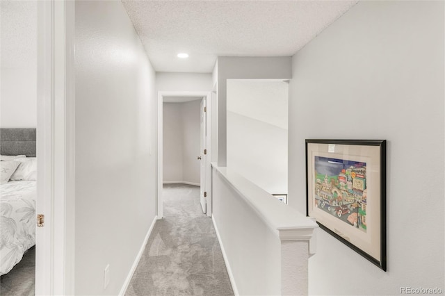 10591 Hyacinth St, Highlands Ranch, CO 80129 - hall featuring carpet floors, a textured ceiling, and baseboards