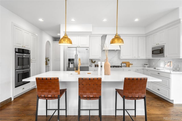 kitchen featuring custom range hood, white cabinetry, stainless steel appliances, and dark wood-type flooring