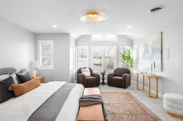 bedroom with lofted ceiling, carpet floors, multiple windows, and visible vents