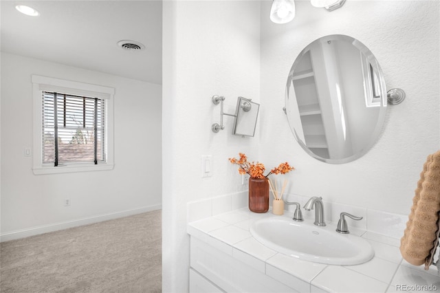 bathroom featuring vanity, visible vents, and baseboards