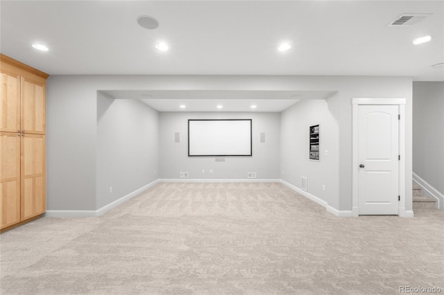 finished basement with light carpet and recessed lighting