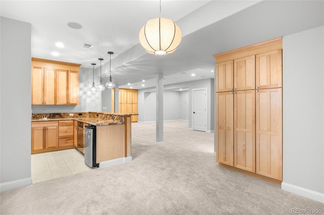 kitchen with a peninsula, light brown cabinetry, and light colored carpet