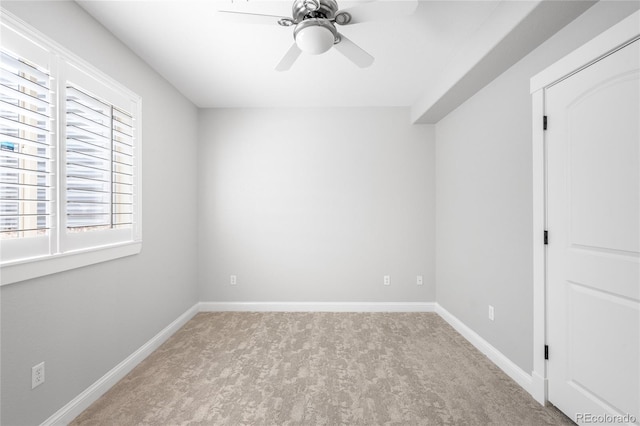 unfurnished bedroom with carpet floors, a ceiling fan, and baseboards