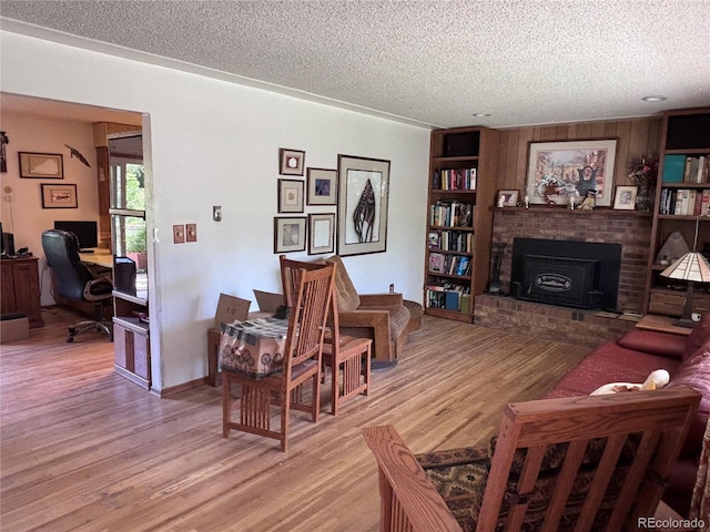 3910 E Orchard Rd, Centennial, CO 80121 - living room with a textured ceiling, light wood-style floors, a desk, and a fireplace
