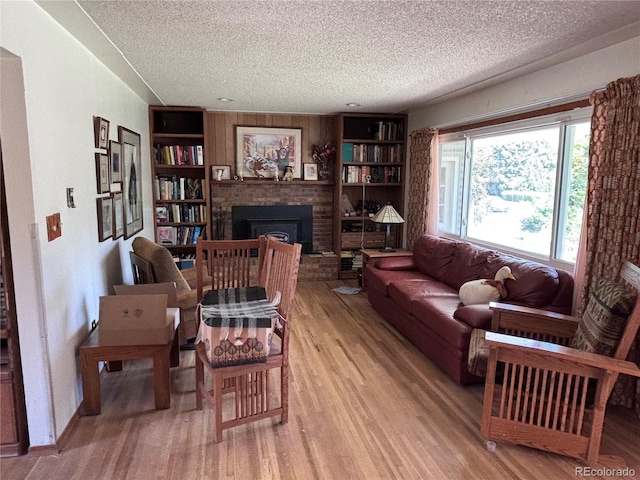 3910 E Orchard Rd, Centennial, CO 80121 - living area with a textured ceiling, a brick fireplace, wood finished floors, and built in features
