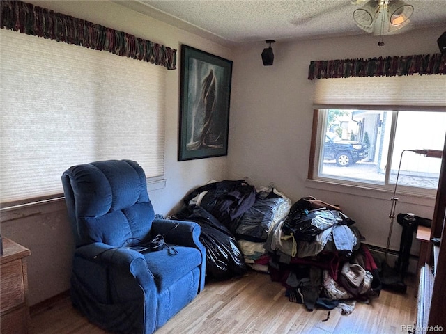 3910 E Orchard Rd, Centennial, CO 80121 - sitting room with wood finished floors, a textured ceiling, and a ceiling fan