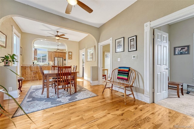 dining area featuring ceiling fan and light wood-type flooring