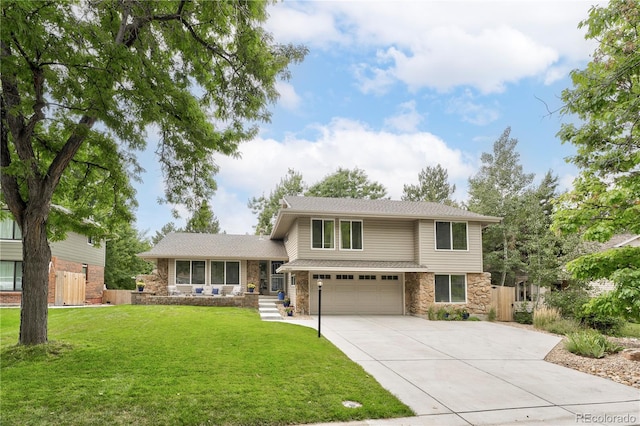 view of front of property with stone siding, a front yard, driveway, and fence