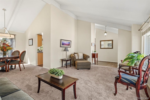 carpeted living area featuring beamed ceiling, high vaulted ceiling, and baseboards