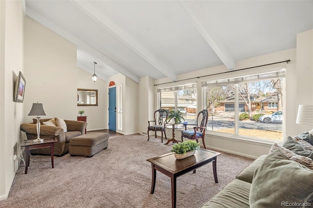 carpeted living room with vaulted ceiling with beams and baseboards