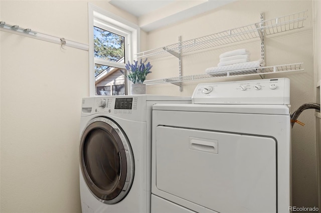 laundry area with laundry area and washer and clothes dryer