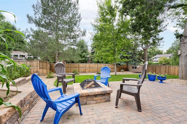 view of patio / terrace with an outbuilding, a fire pit, and a fenced backyard