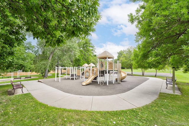 community jungle gym featuring a lawn