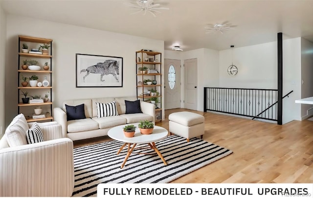 living room featuring hardwood / wood-style floors and ceiling fan