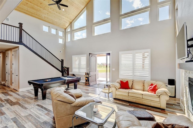 3308 County Road 19, Fort Lupton, CO 80621 - living area with a towering ceiling, healthy amount of natural light, a fireplace, ceiling fan, and light wood finished floors