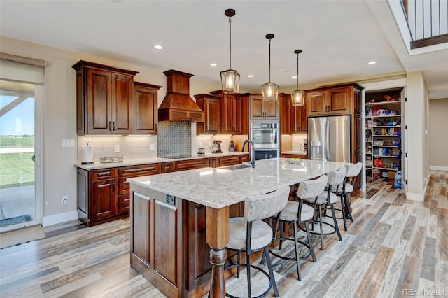 3308 County Road 19, Fort Lupton, CO 80621 - kitchen featuring custom exhaust hood, baseboards, light wood-style flooring, and recessed lighting