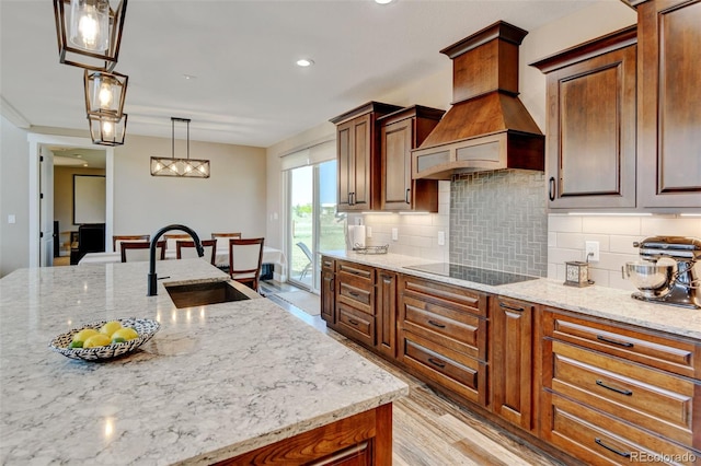 3308 County Road 19, Fort Lupton, CO 80621 - kitchen with a sink, custom exhaust hood, black electric cooktop, tasteful backsplash, and light stone counters