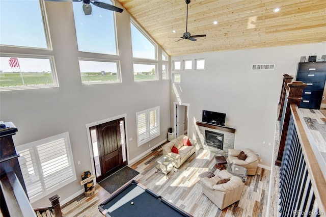 3308 County Road 19, Fort Lupton, CO 80621 - living area with a ceiling fan, high vaulted ceiling, wooden ceiling, a stone fireplace, and wood finished floors