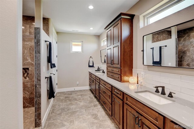 3308 County Road 19, Fort Lupton, CO 80621 - bathroom with double vanity, a walk in shower, tasteful backsplash, baseboards, and recessed lighting