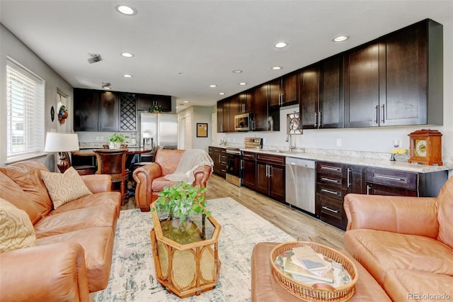 3308 County Road 19, Fort Lupton, CO 80621 - living room with light wood-style flooring, recessed lighting, and wet bar