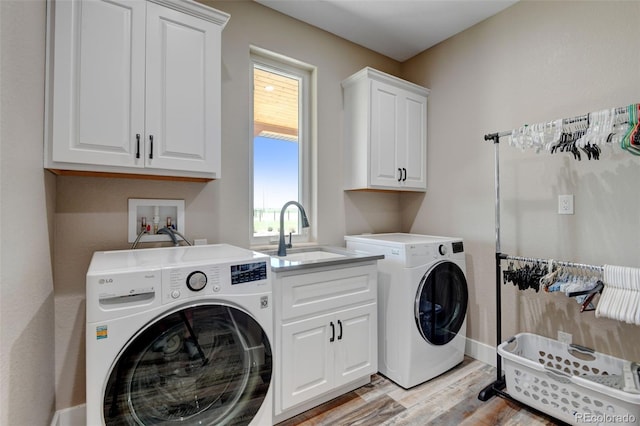3308 County Road 19, Fort Lupton, CO 80621 - washroom with cabinet space, washing machine and clothes dryer, light wood finished floors, and baseboards