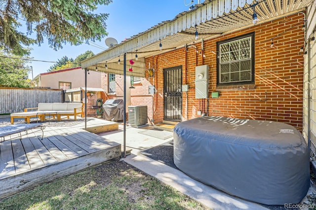 wooden terrace featuring central AC unit