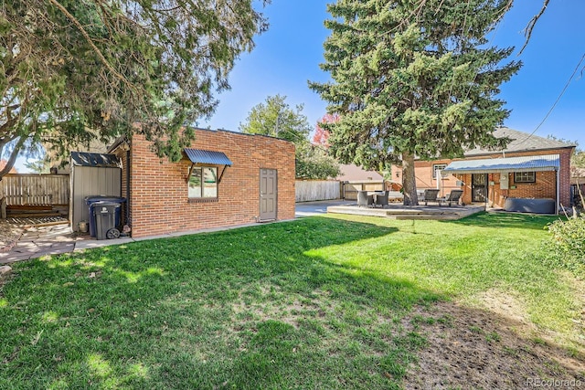 view of yard featuring a shed and a patio area