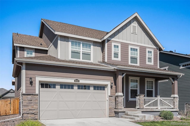 craftsman-style home with a porch, a garage, stone siding, driveway, and board and batten siding