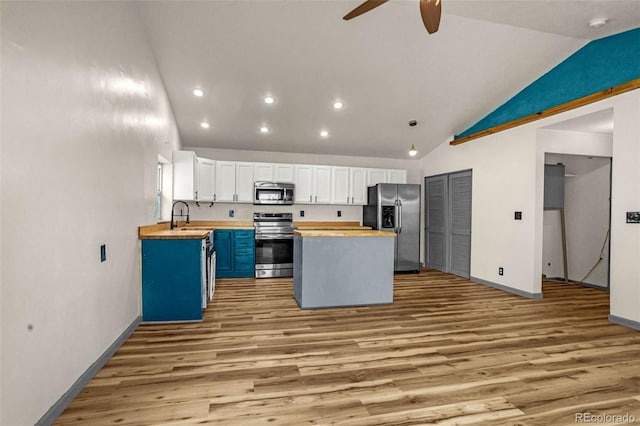 86 Will Stutley Dr, Divide, CO 80814 - kitchen with appliances with stainless steel finishes, wooden counters, lofted ceiling, a ceiling fan, and light wood-type flooring