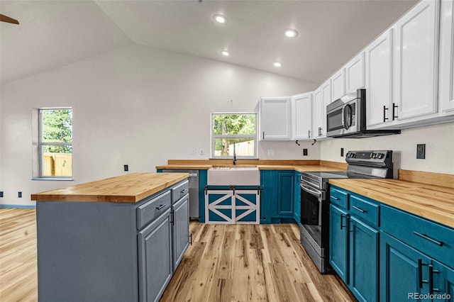 86 Will Stutley Dr, Divide, CO 80814 - kitchen featuring wood counters, appliances with stainless steel finishes, a sink, lofted ceiling, and white cabinets