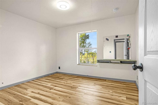 86 Will Stutley Dr, Divide, CO 80814 - empty room featuring wood finished floors, a smoke detector, and baseboards