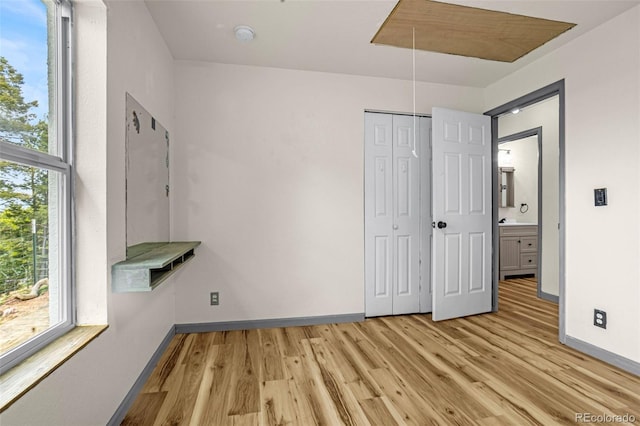 86 Will Stutley Dr, Divide, CO 80814 - unfurnished bedroom featuring attic access, light wood-type flooring, baseboards, and a closet