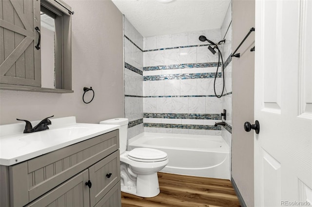 86 Will Stutley Dr, Divide, CO 80814 - full bathroom featuring vanity, toilet, wood finished floors, shower / bath combination, and a textured ceiling
