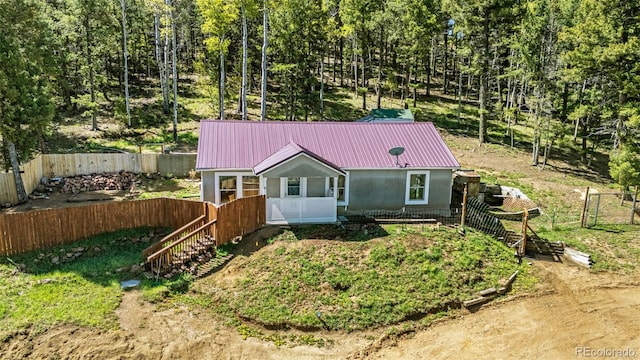 86 Will Stutley Dr, Divide, CO 80814 - view of front of home featuring metal roof, a fenced backyard, and stucco siding