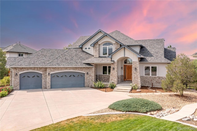 view of front of house featuring a garage, concrete driveway, and roof with shingles