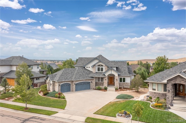 french provincial home featuring a front lawn, a residential view, driveway, and an attached garage