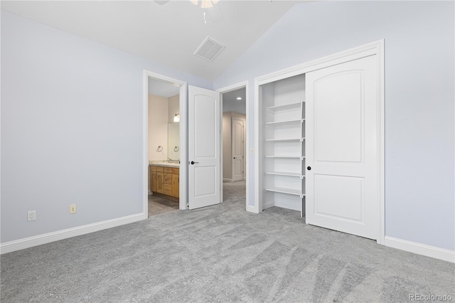 unfurnished bedroom with lofted ceiling, baseboards, visible vents, and light colored carpet