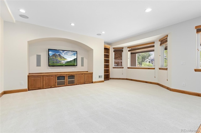 unfurnished living room with recessed lighting, carpet, and baseboards